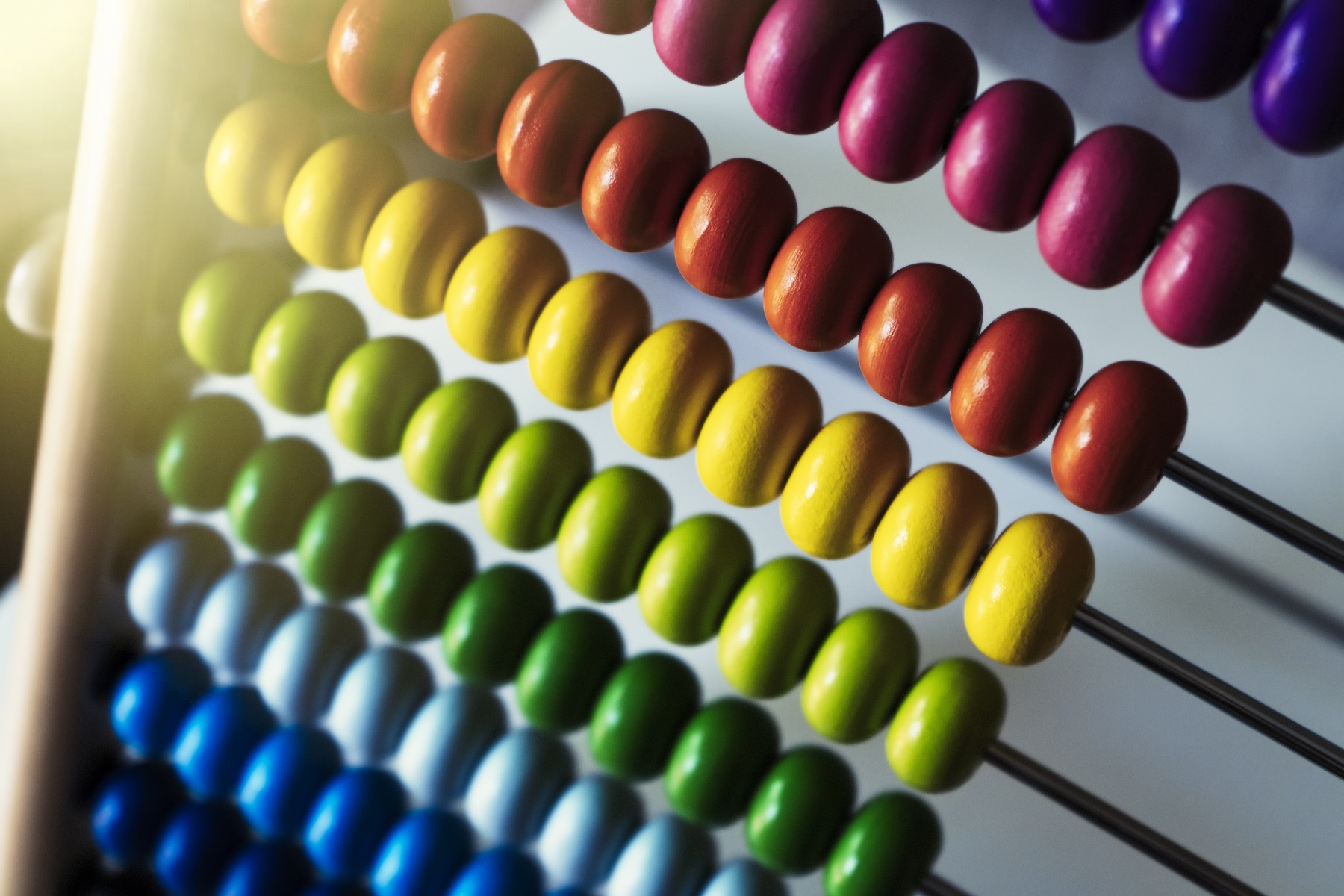 Abacus with colorful beads closeup. Lens flare