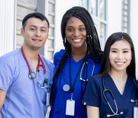 Three nursing students: Latino male, African American female, Asian female