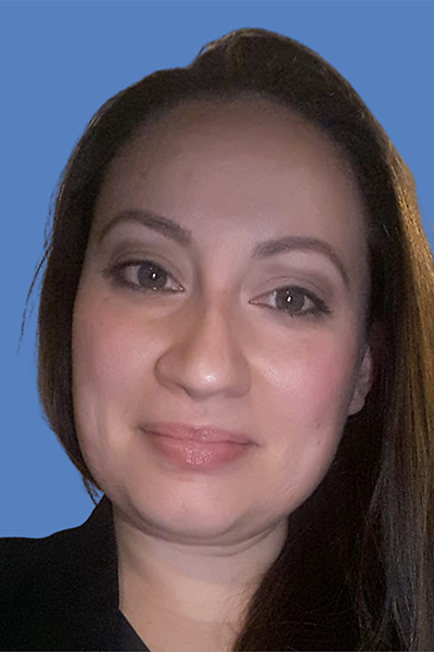 Photo of Ivelisse Caraballo, a Latina woman in professional attire