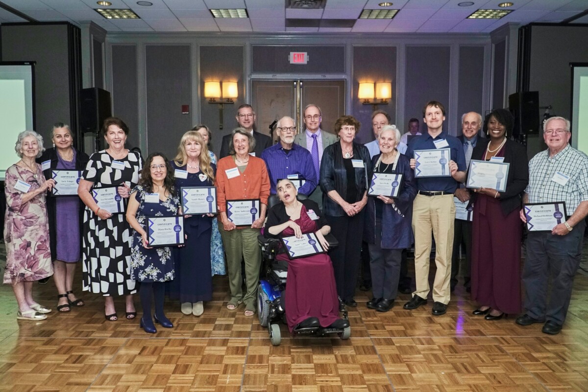All of the honorees who were present pose with certificates on the dance floor